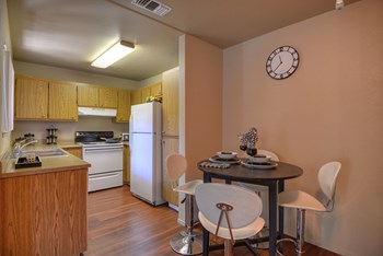 Dining Area with Wood Inspired Floor, Washer/Dryer, Refrigerator, Clock, Ceiling Light